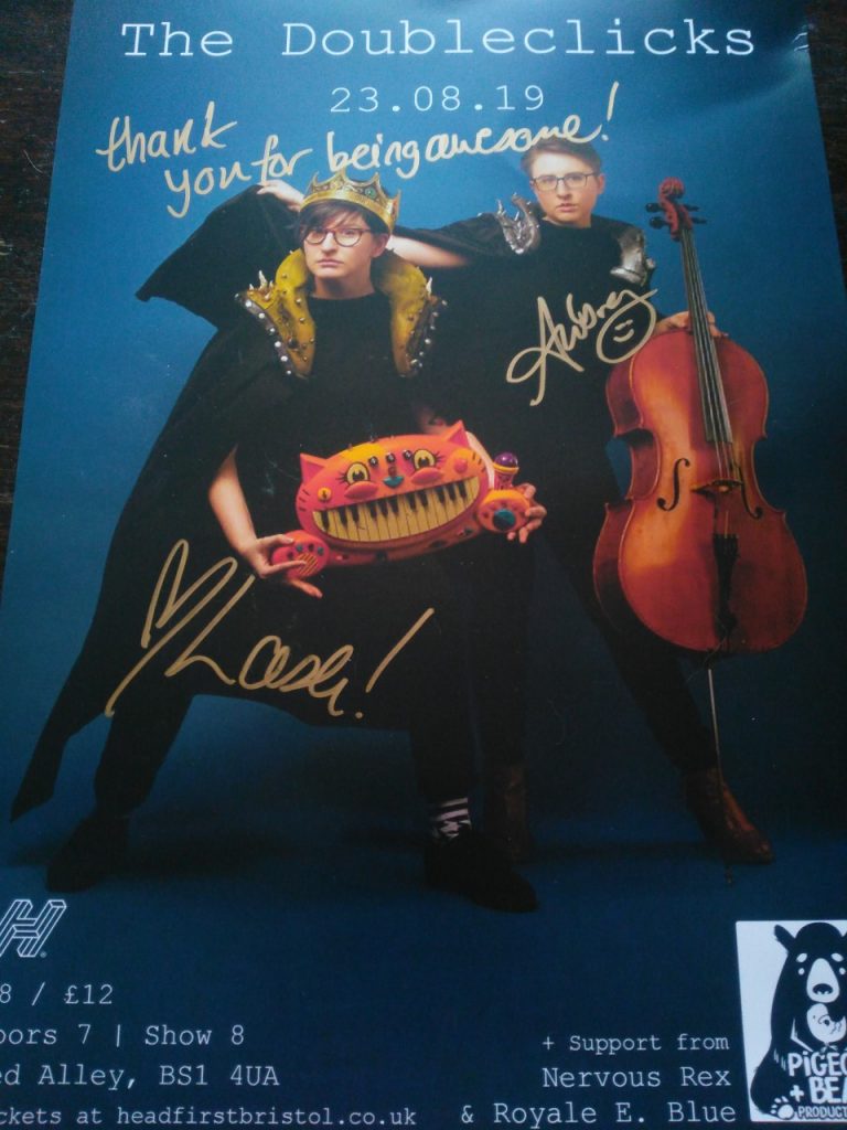 The Doubleclick's tour poster with Aubrey and Laser in capes and crowns. Signed by them in gold sharpie.