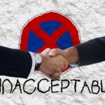 a handshake but there's a cross over it and it says UNACCEPTABLE
