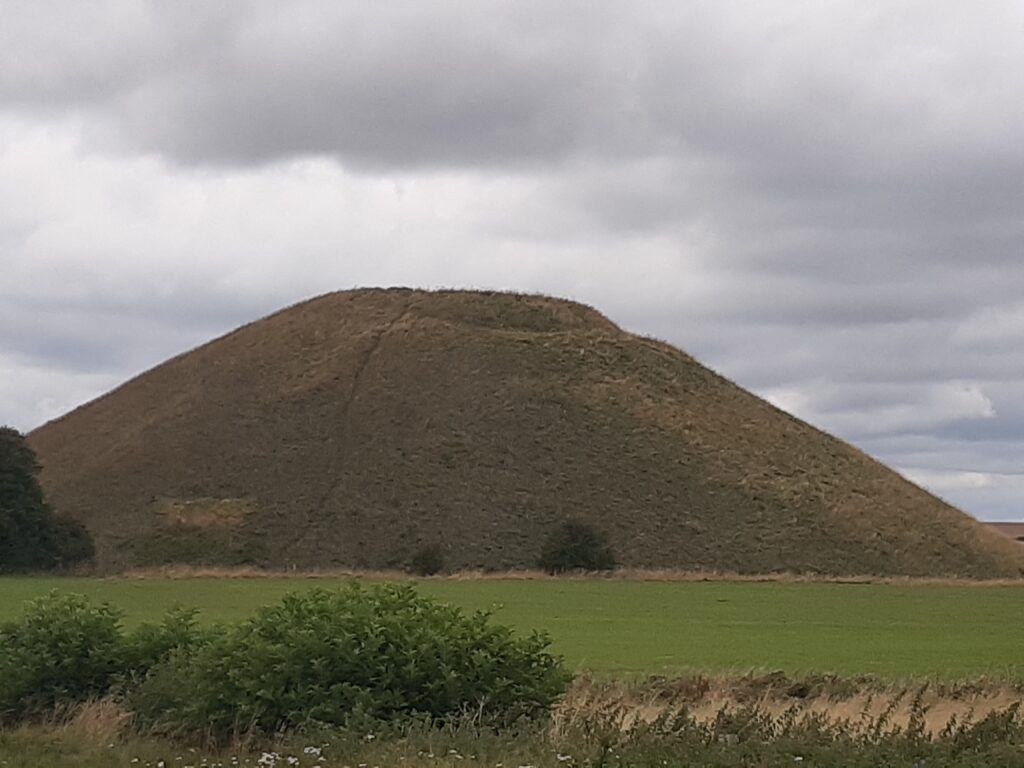 An ancient constructed hill with an unnatural shape and a flat top
